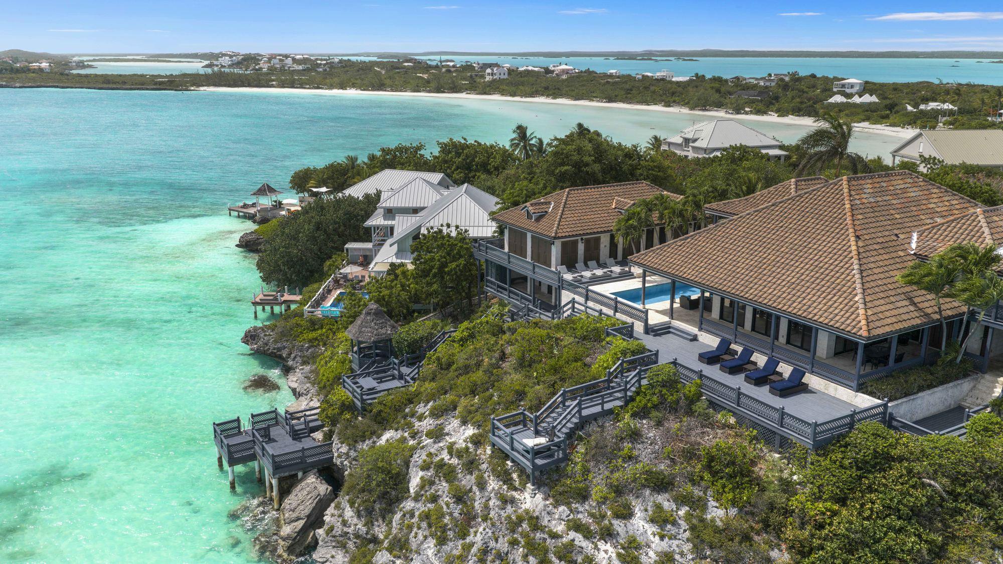 Aerial view of Villa Seacliff on the cliff top at Ocean Point, with its deck and stairs running down to the water